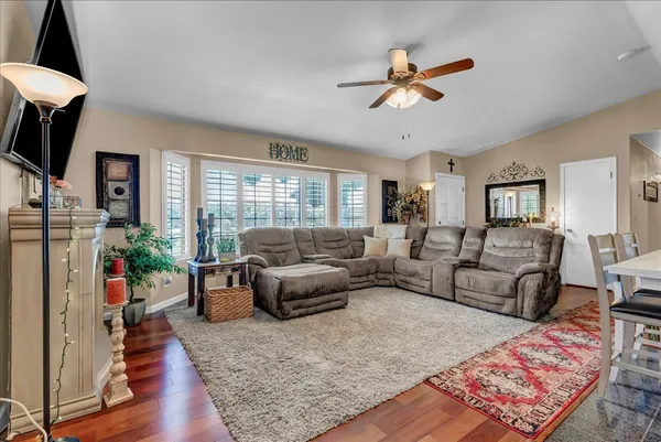 a living room with furniture a flat screen tv and a fireplace
