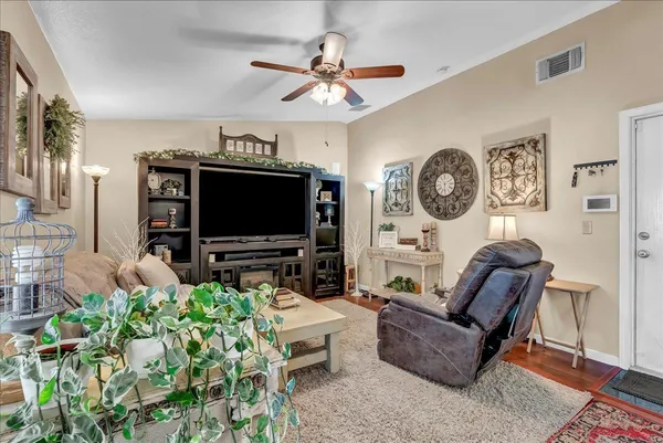 a living room with furniture a rug and a window