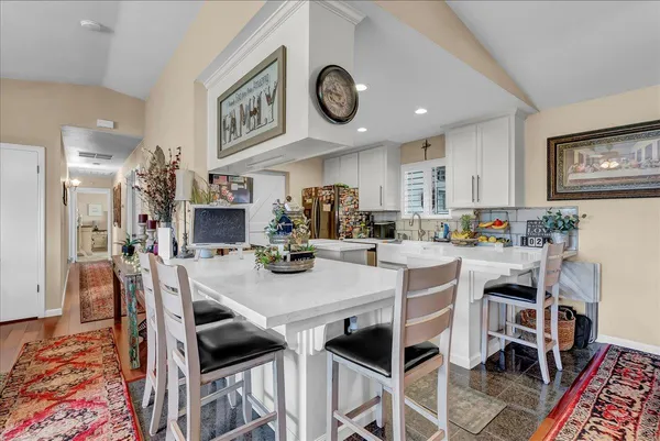a kitchen with stainless steel appliances granite countertop a sink a stove and a microwave