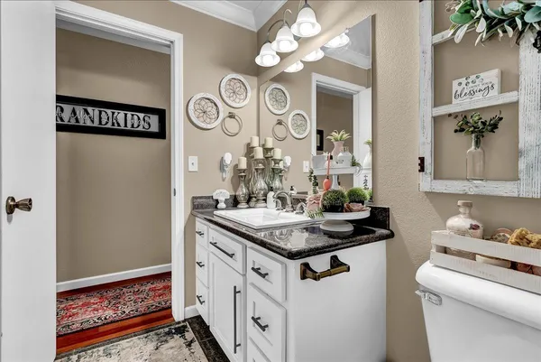 a bathroom with a double vanity sink toilet and shower