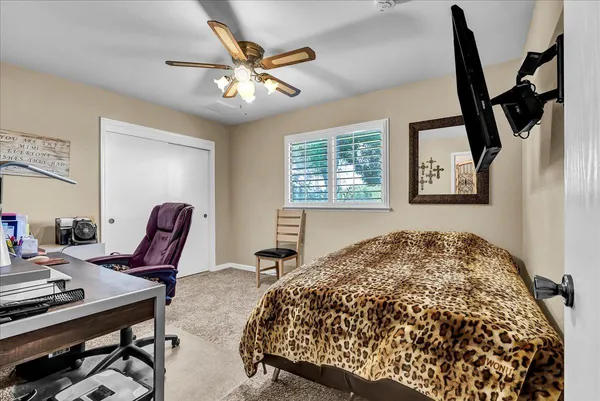a bedroom with a bed and lamp