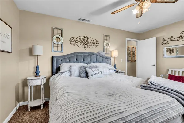a bedroom with a bed and flat screen tv