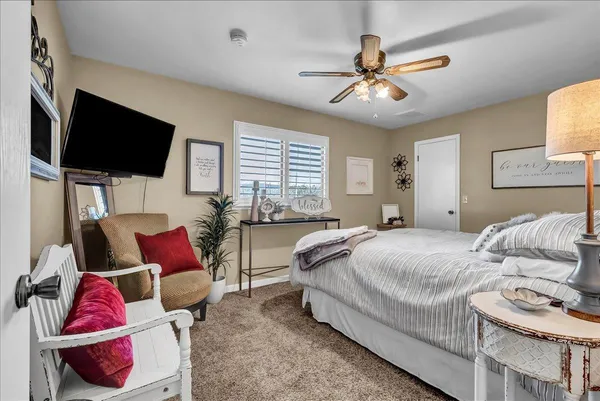 a spacious bedroom with a bed and a chandelier