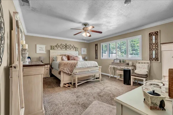 a bedroom with a bed and flat screen tv