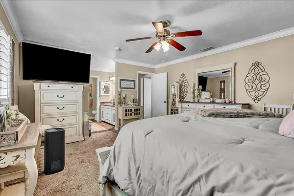 a spacious bedroom with a bed and a dresser