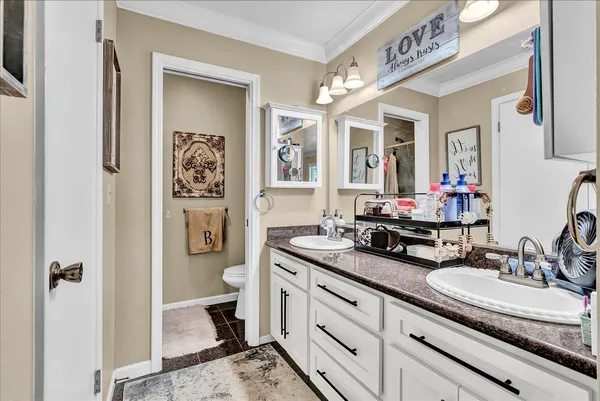 a bathroom with a double vanity sink and a mirror