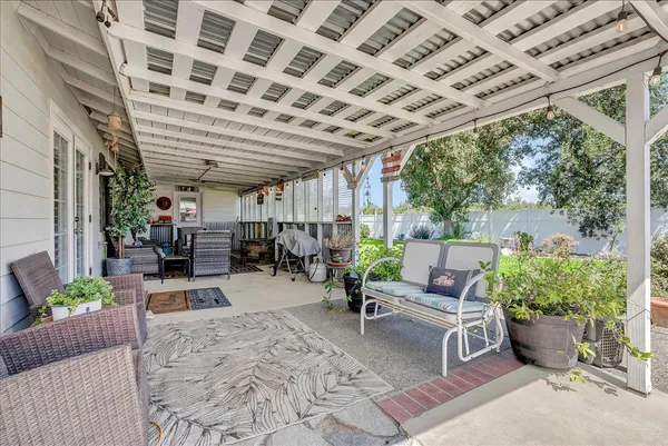 a view of a patio with a table and chairs under an umbrella