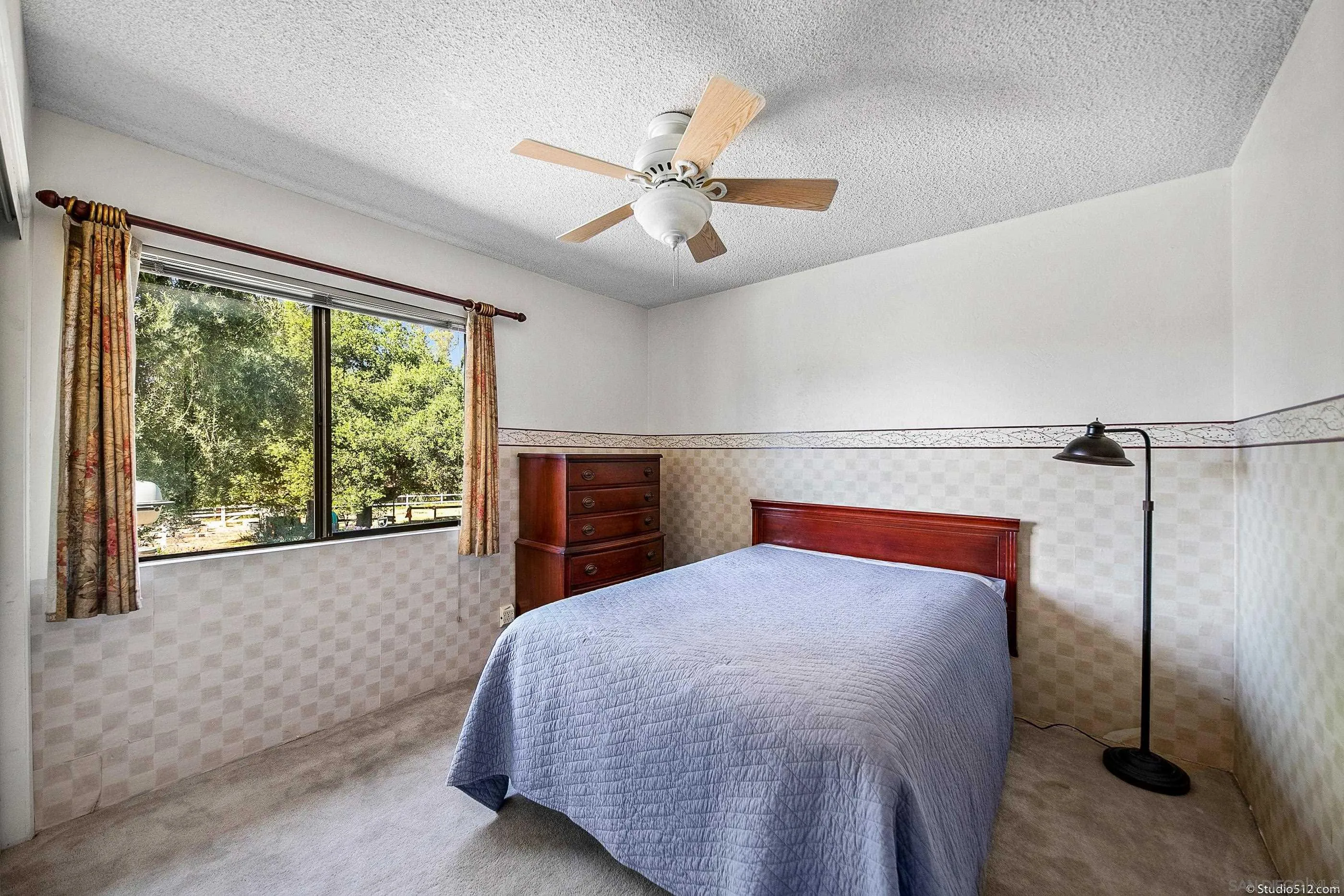 14847 Fruitvale Road Valley Center, CA 92082 - Photo 13 of 34 a bedroom with a large bed and a chandelier