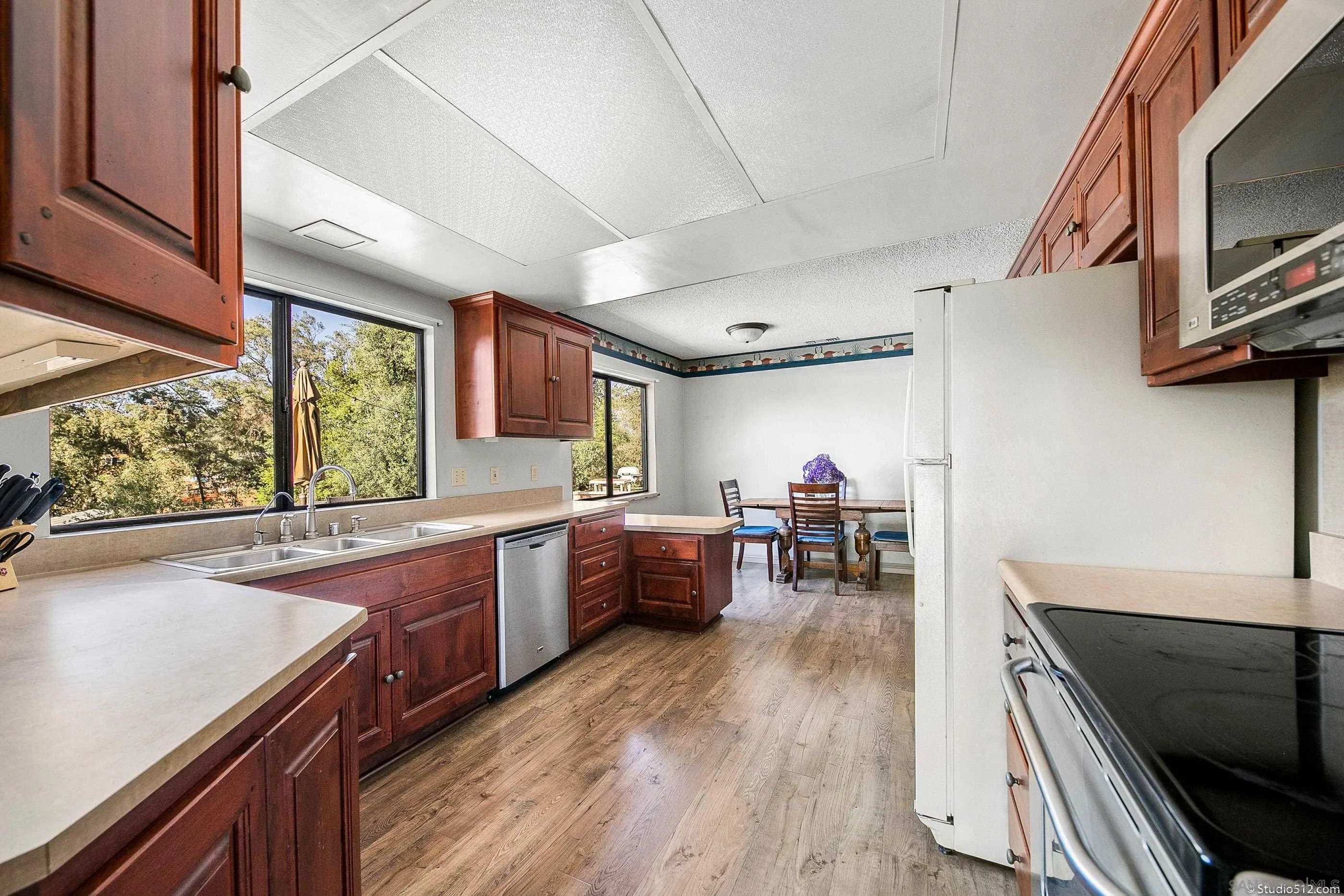 14847 Fruitvale Road Valley Center, CA 92082 - Photo 5 of 34 a kitchen with stainless steel appliances granite countertop sink stove top oven and cabinets