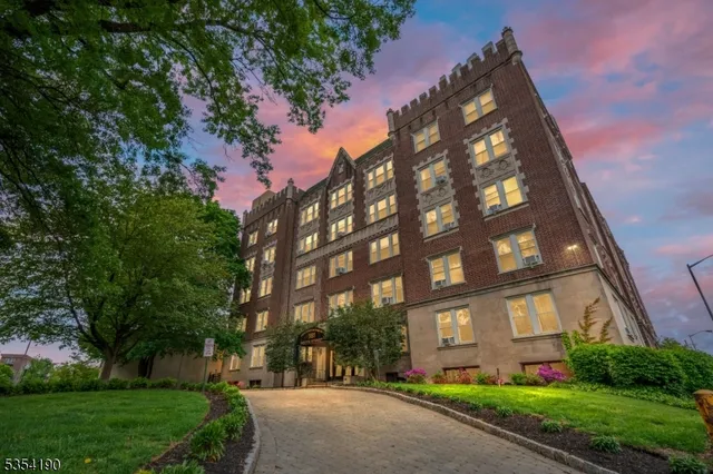 a view of a brick building next to a yard
