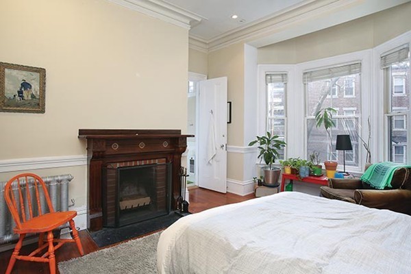 17 High Street, Unit 2 Brookline, MA 02445 - Photo 5 of 6 a bedroom with a bed and a fireplace