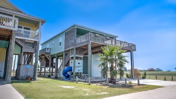 a view of a house with backyard porch and sitting area
