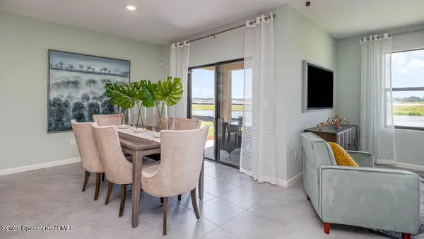 a dining room with furniture and window