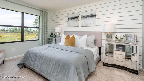 a bedroom with a bed and window