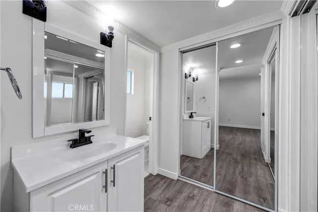 a bathroom with a sink shower and a mirror