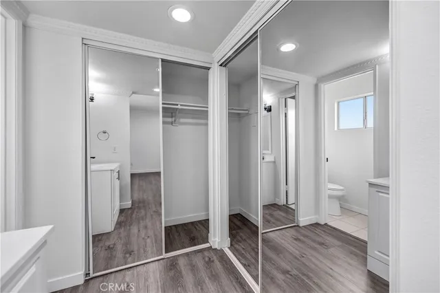 a bathroom with a glass shower door a sink and a mirror