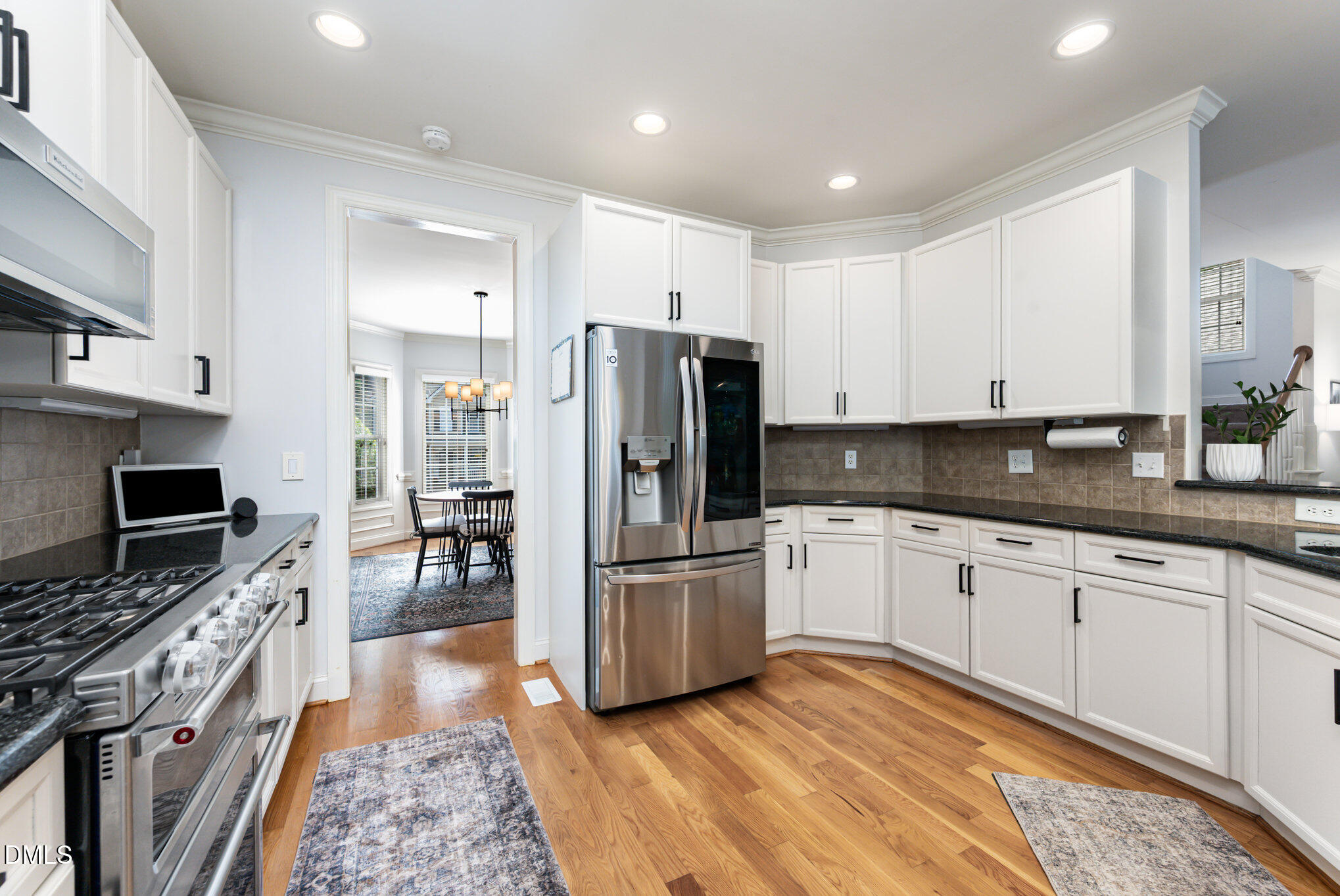 1613 Strategy Way Wake Forest, NC 27587 - Photo 10 of 40 a kitchen with stainless steel appliances granite countertop a refrigerator a stove a sink and a microwave