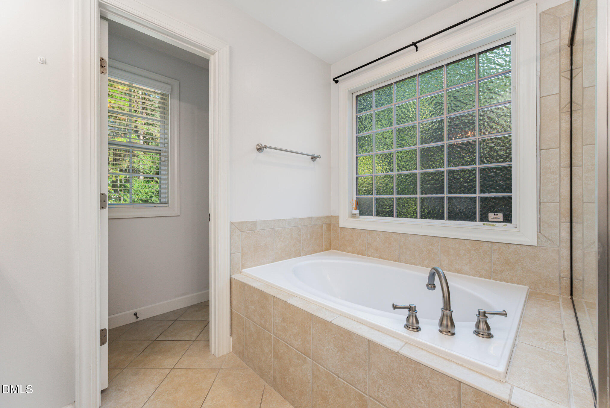 1613 Strategy Way Wake Forest, NC 27587 - Photo 17 of 40 a bathroom with a bathtub and next to a window
