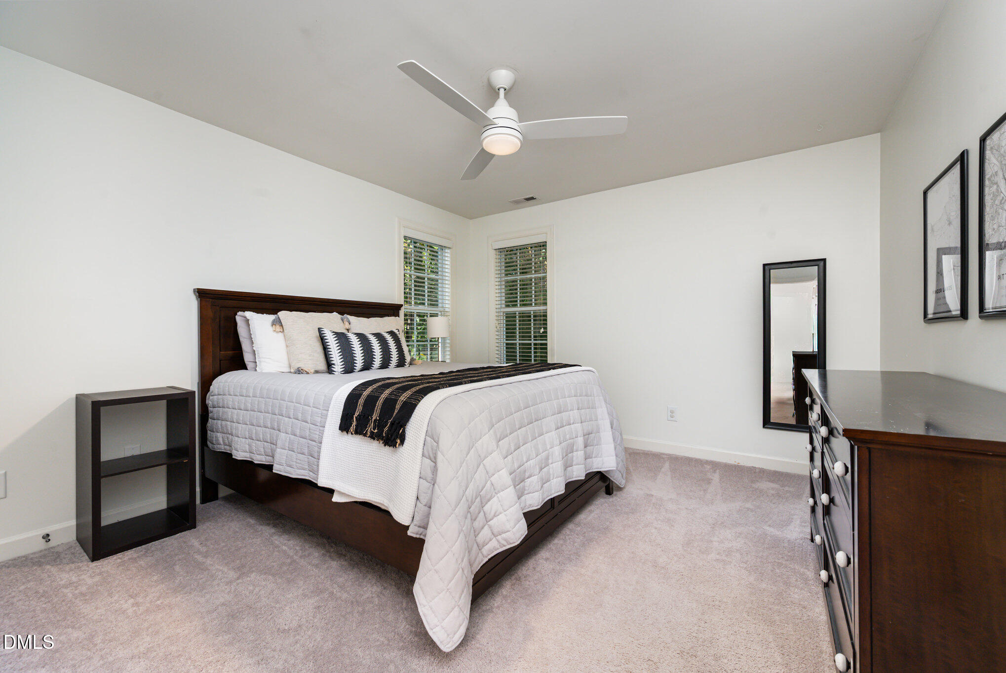 1613 Strategy Way Wake Forest, NC 27587 - Photo 19 of 40 a bed sitting in a bedroom next to a window with a bookshelf
