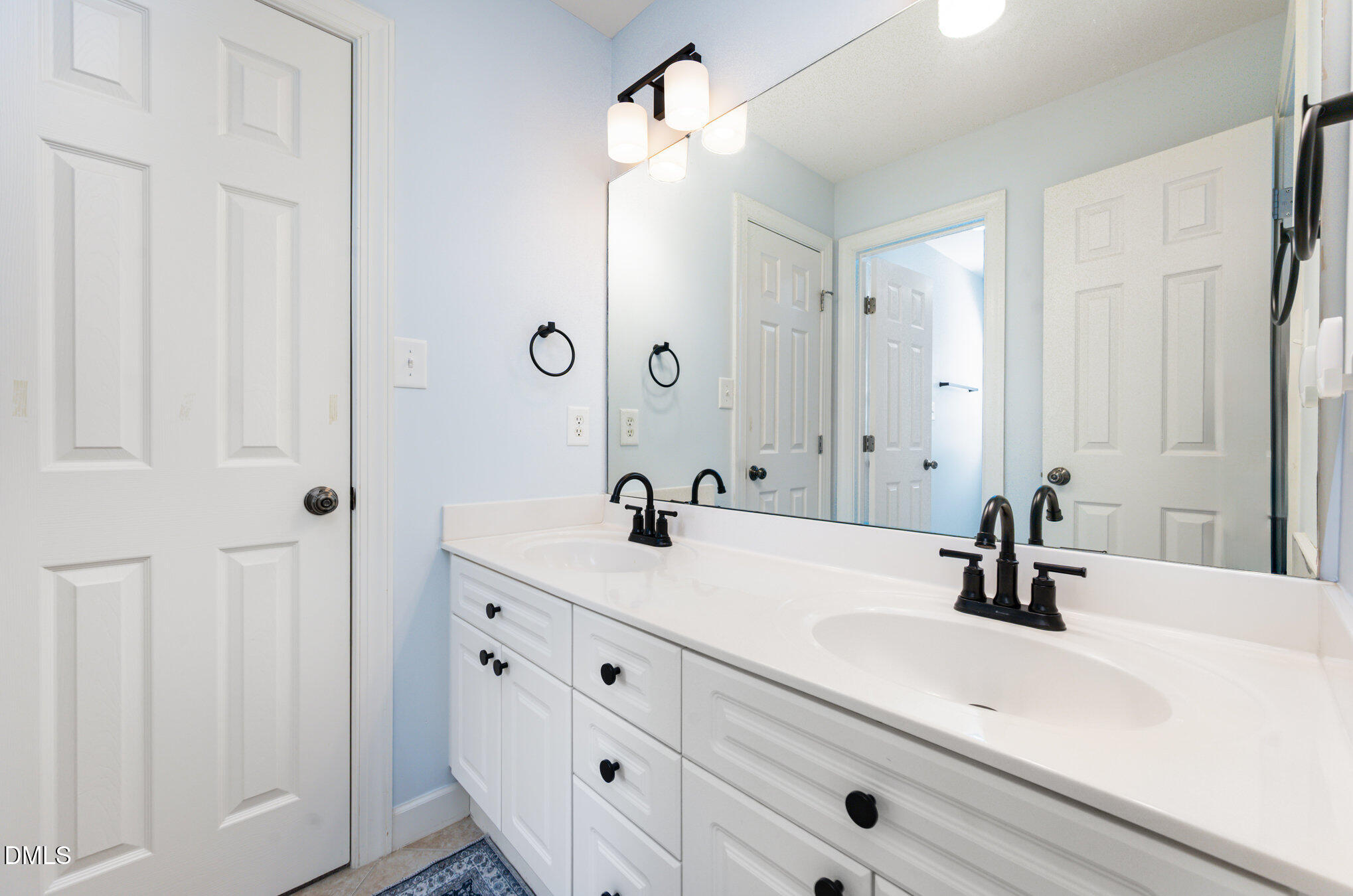 1613 Strategy Way Wake Forest, NC 27587 - Photo 21 of 40 a bathroom with double vanity sink and a mirror
