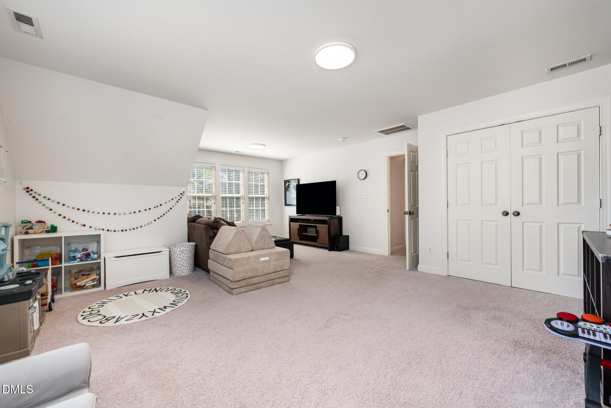 1613 Strategy Way Wake Forest, NC 27587 - Photo 23 of 40 a living room with furniture a flat screen tv and a fireplace