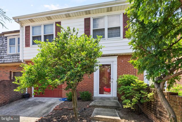 a front view of a house with plants