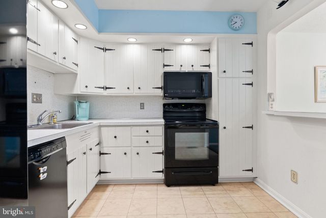 a kitchen with stainless steel appliances and refrigerator