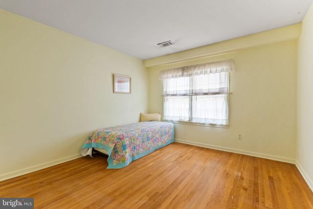 a bedroom with a bed and a dresser in it