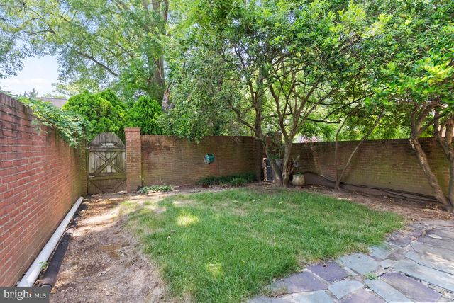 a view of backyard with seating area and green space