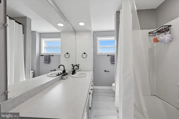 a bathroom with a sink a tub and shower