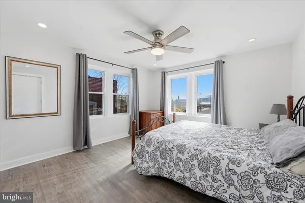 a bedroom with a large bed and a chandelier