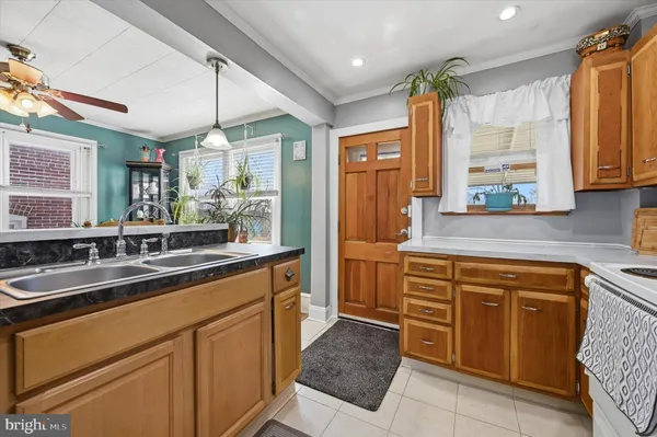 a kitchen with a sink stove and cabinets