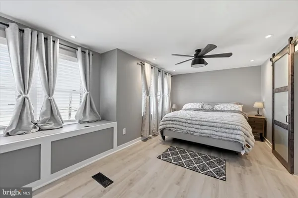 a bedroom with a large bed and a window