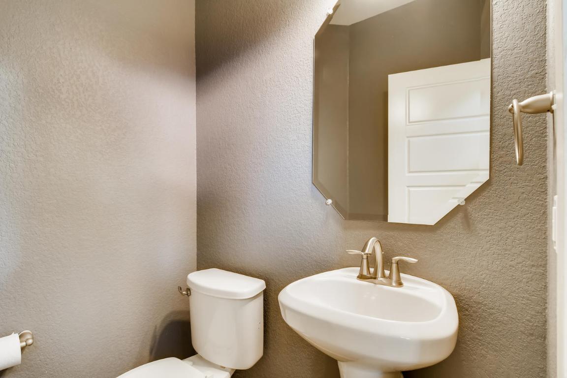 16229 Travesia Way Austin, TX 78728 - Photo 12 of 28 a bathroom with a toilet sink and mirror