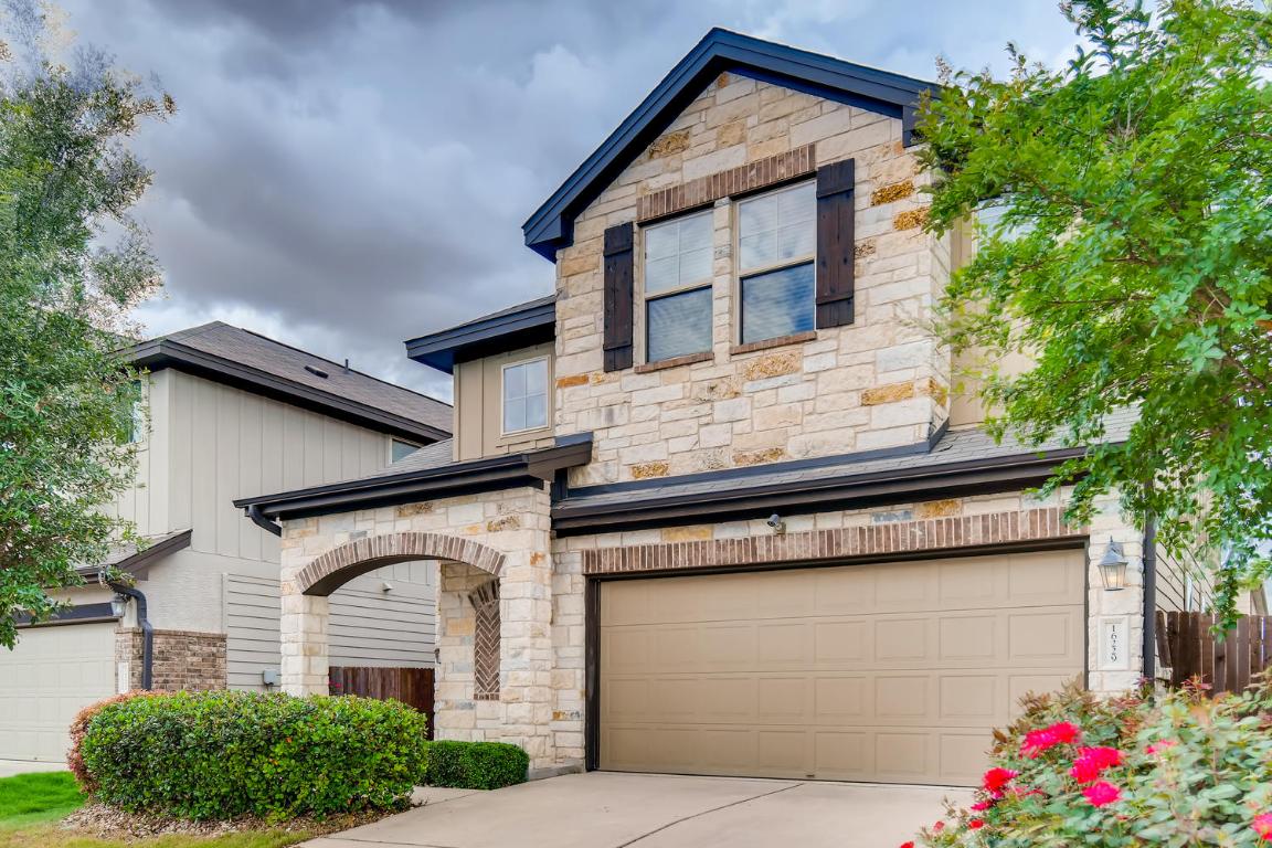 16229 Travesia Way Austin, TX 78728 - Photo 2 of 28 a front view of a house with a yard