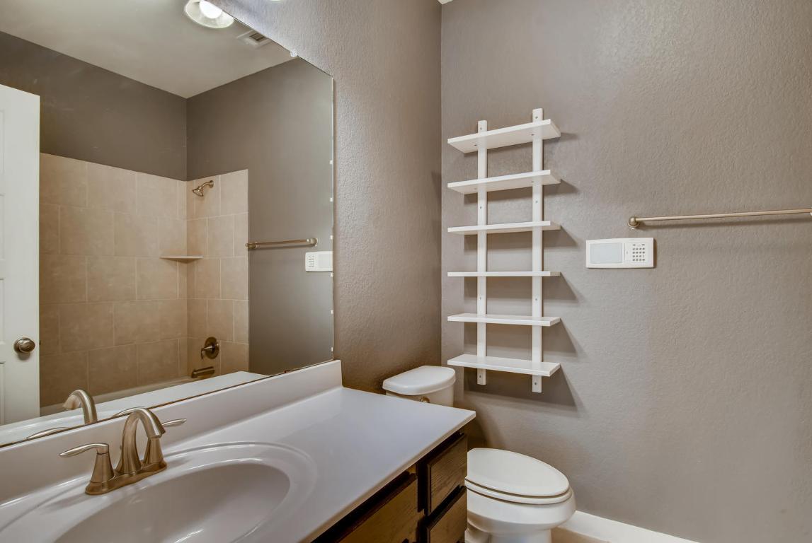 16229 Travesia Way Austin, TX 78728 - Photo 21 of 28 a bathroom with a sink a toilet and a large mirror
