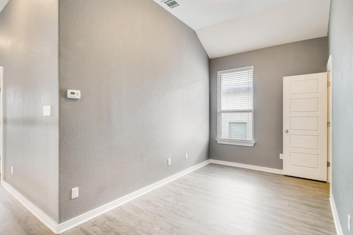 16229 Travesia Way Austin, TX 78728 - Photo 23 of 28 an empty room with windows and closet