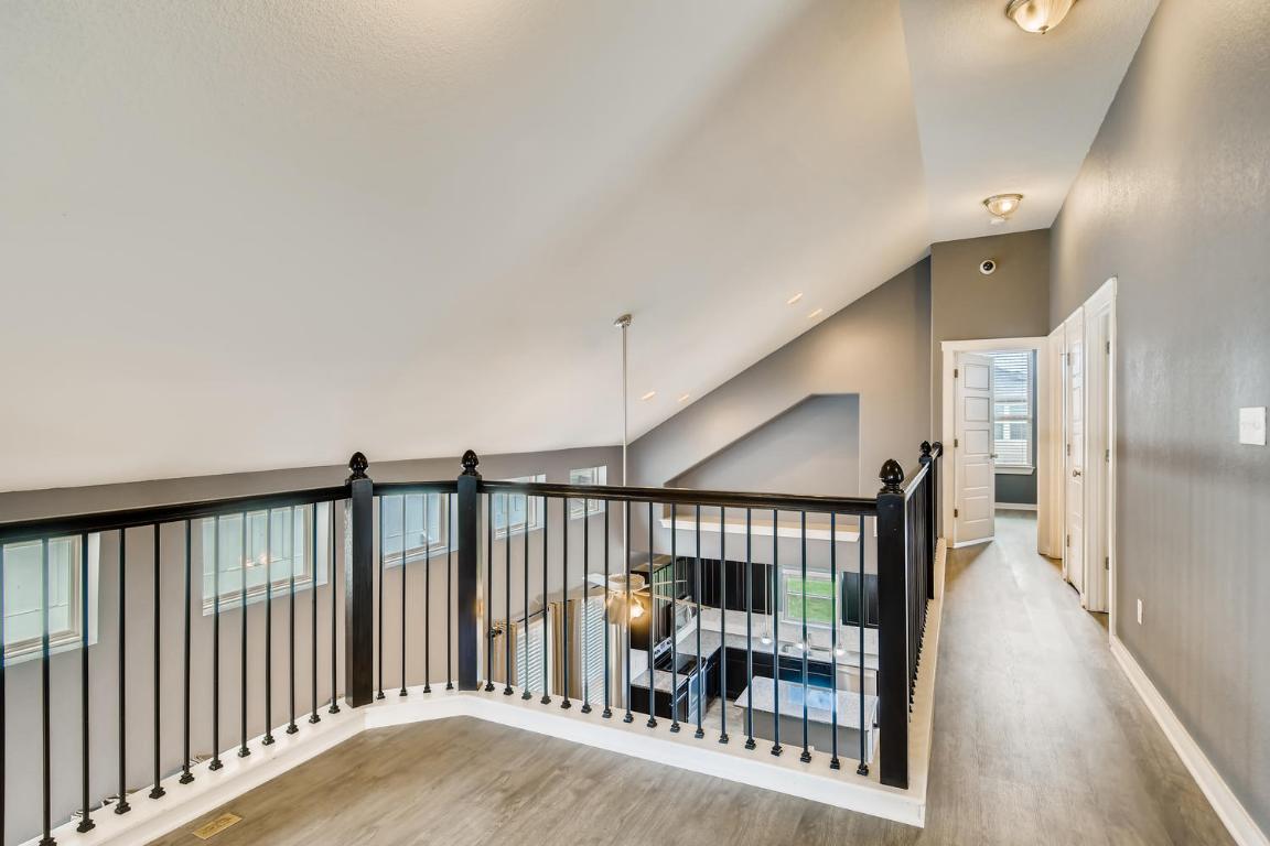 16229 Travesia Way Austin, TX 78728 - Photo 25 of 28 a view of a hallway with wooden floor and stairs