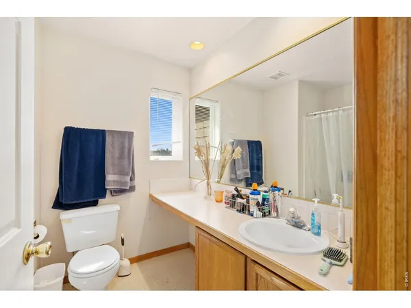 a bathroom with a sink vanity mirror and toilet