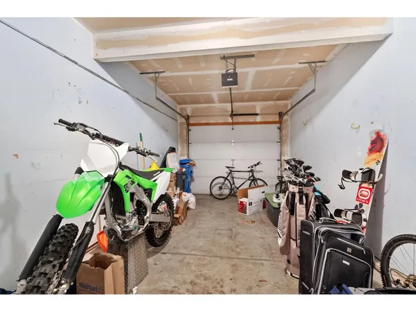 a view of a garage with a bike and white table