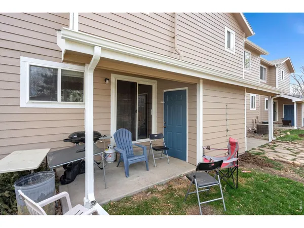 a backyard of a house with outdoor seating
