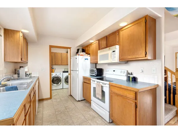 a kitchen with a sink stove and refrigerator