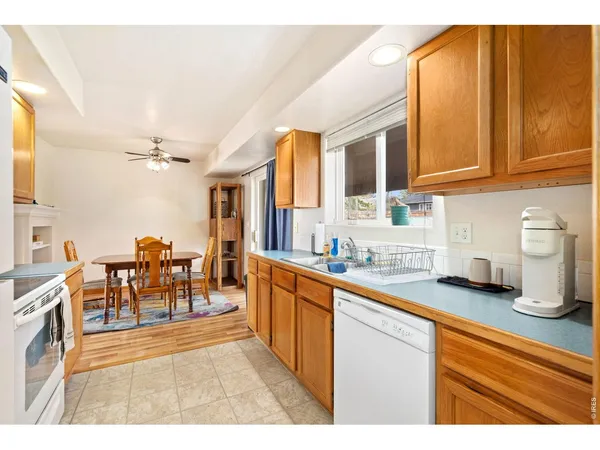 a kitchen with stainless steel appliances granite countertop sink cabinets and wooden floor