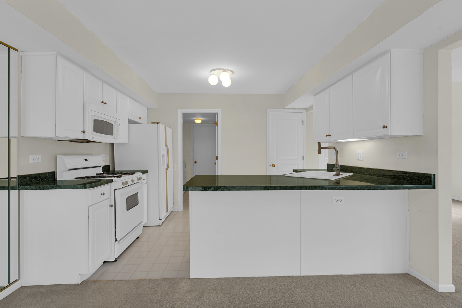 148 Locksley Drive Streamwood, IL 60107 - Photo 11 of 20 a kitchen with stainless steel appliances granite countertop a stove a sink and white cabinets