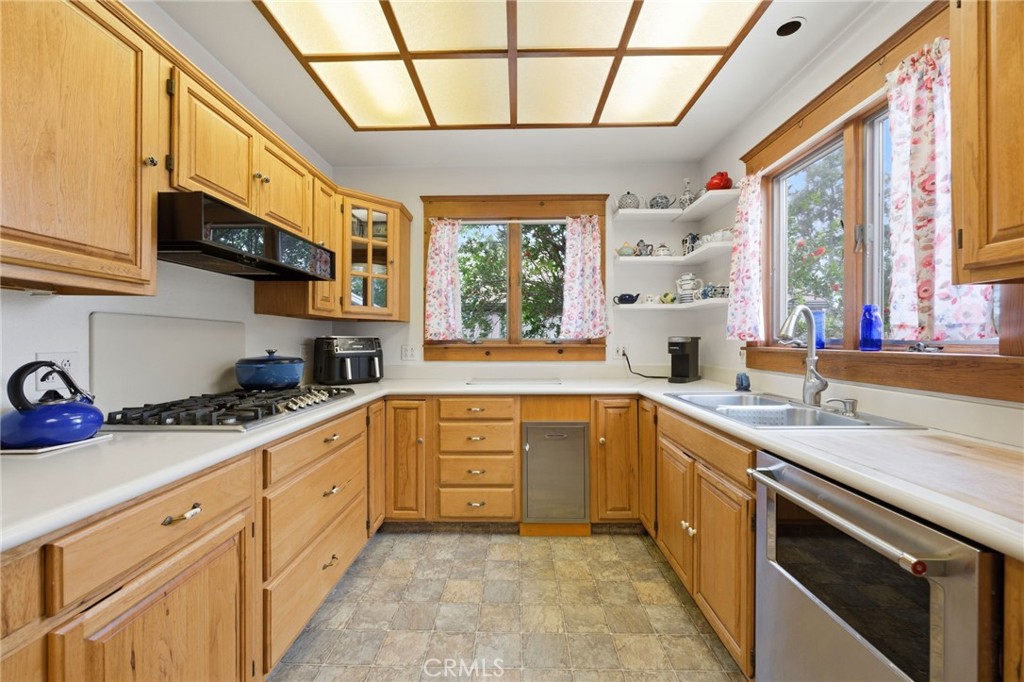 4456 12th Street Riverside, CA 92501 - Photo 17 of 70 a kitchen with a sink window and cabinets