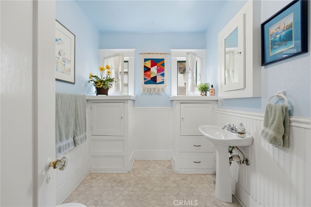 4456 12th Street Riverside, CA 92501 - Photo 24 of 70 a bathroom with a sink a mirror and a shower