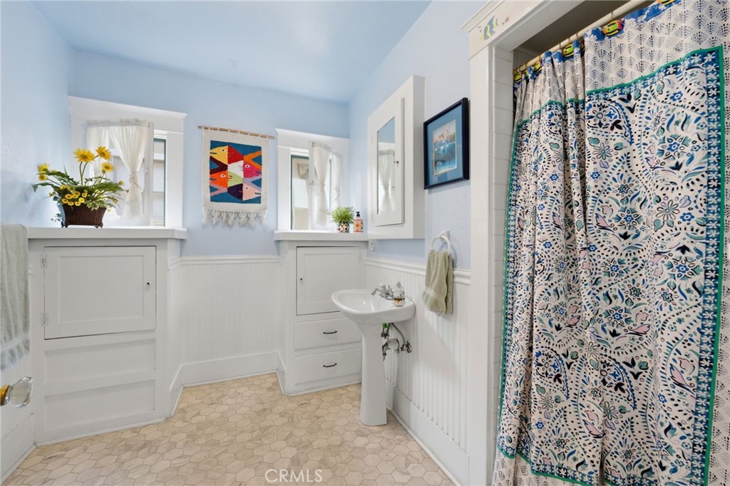 4456 12th Street Riverside, CA 92501 - Photo 25 of 70 a bathroom with a sink and a shower curtain