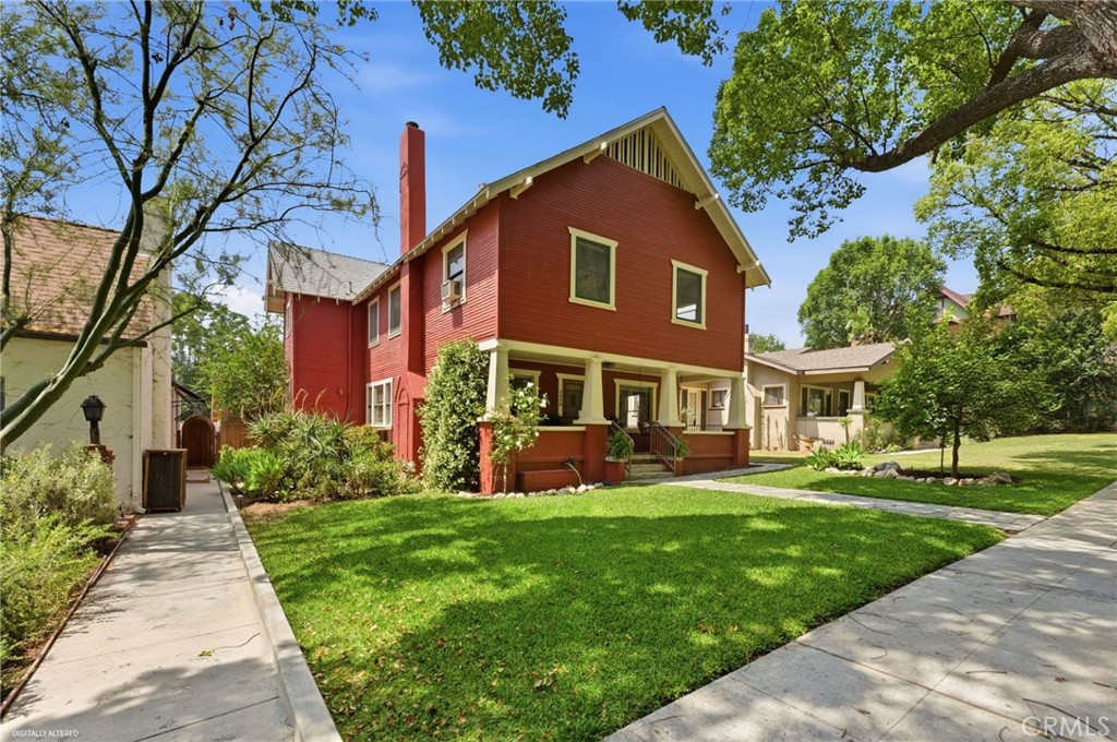4456 12th Street Riverside, CA 92501 - Photo 3 of 70 a front view of a house with garden and trees