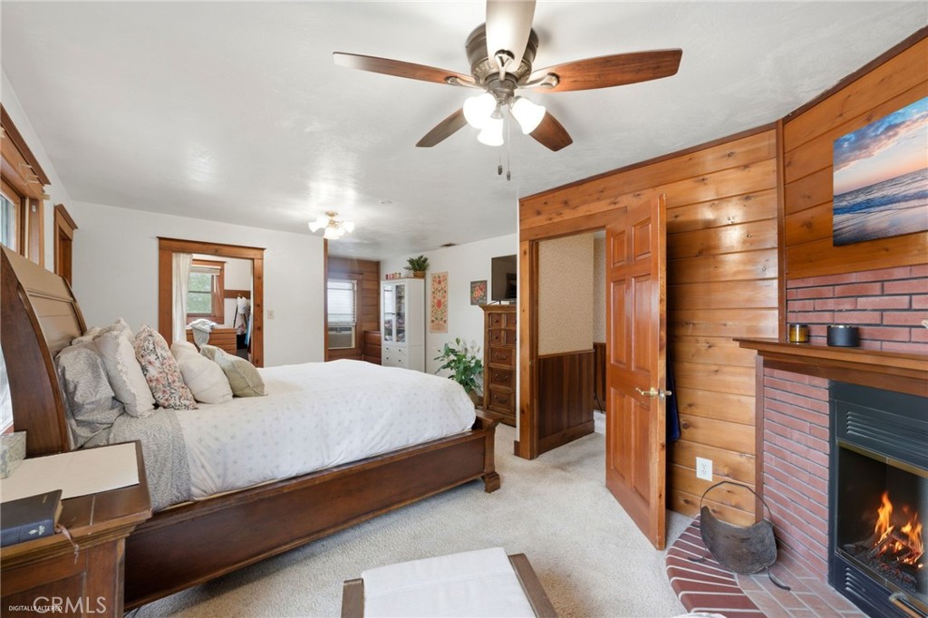 4456 12th Street Riverside, CA 92501 - Photo 32 of 70 a bedroom with a bed a fireplace and a chandelier