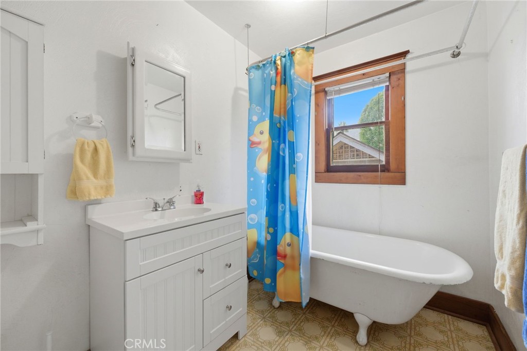 4456 12th Street Riverside, CA 92501 - Photo 38 of 70 a bathroom with a sink mirror vanity and bathtub